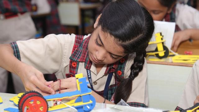 A girl making her science project