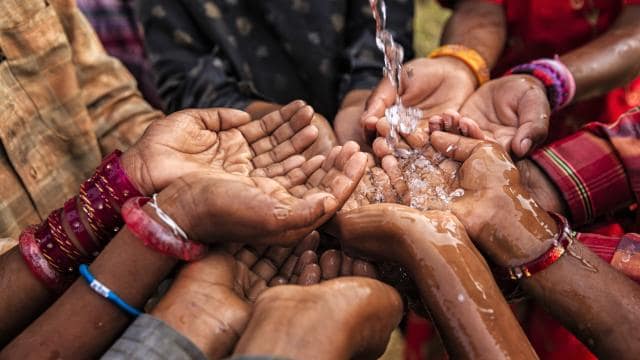 hands reaching for water