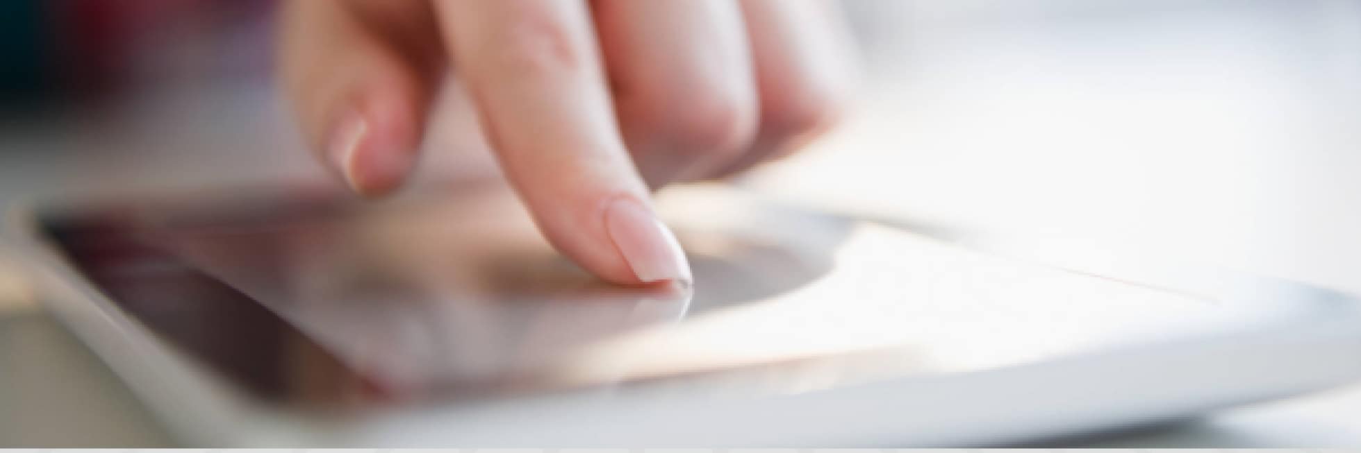 A person's finger touches a glowing tablet screen, interacting with the device.